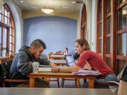 Two students studying in University Hall.