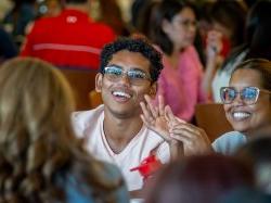 A student and his mother smile brightly.