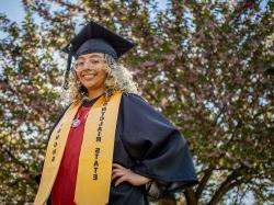 Student 马里亚纳Luna-马丁内斯 in graduation cap and gown with a gold honors stole.