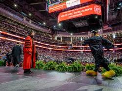 Joseph Lepinski dances across the Commencement stage.