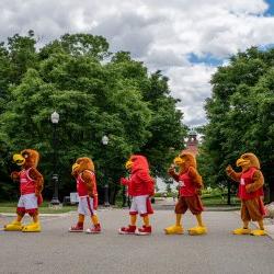 Five students dressed as Rocky walk across campus.