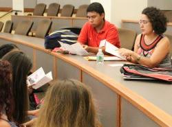 Photo of Prof. Maria Jose Garcia Vizcaino sitting and talking with students at an orientation session.