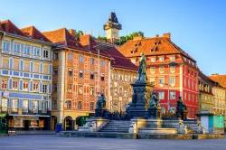 Painted facades and the Clocktower in the old town of Graz, Austria