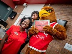 Two people and Rocky for National Day of Service